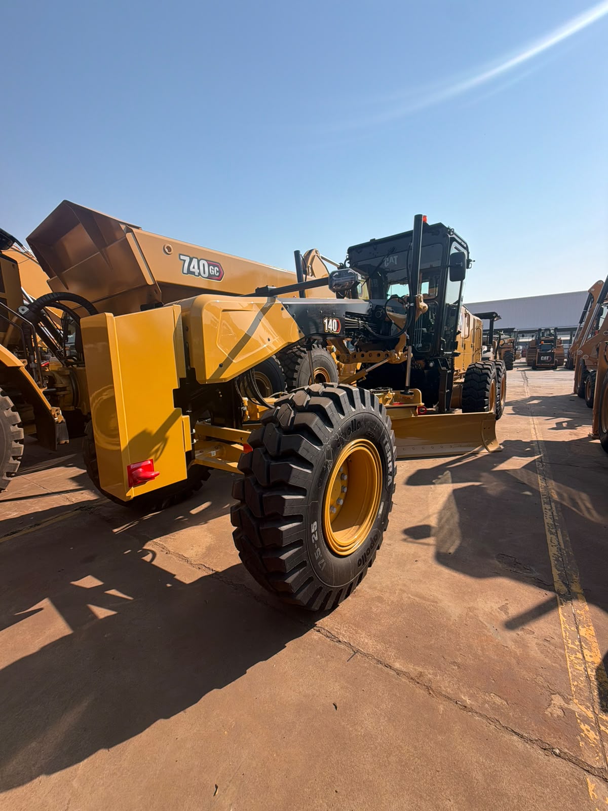 CAT 140 grader and CAT 740 dump truck in the Che Lele fleet