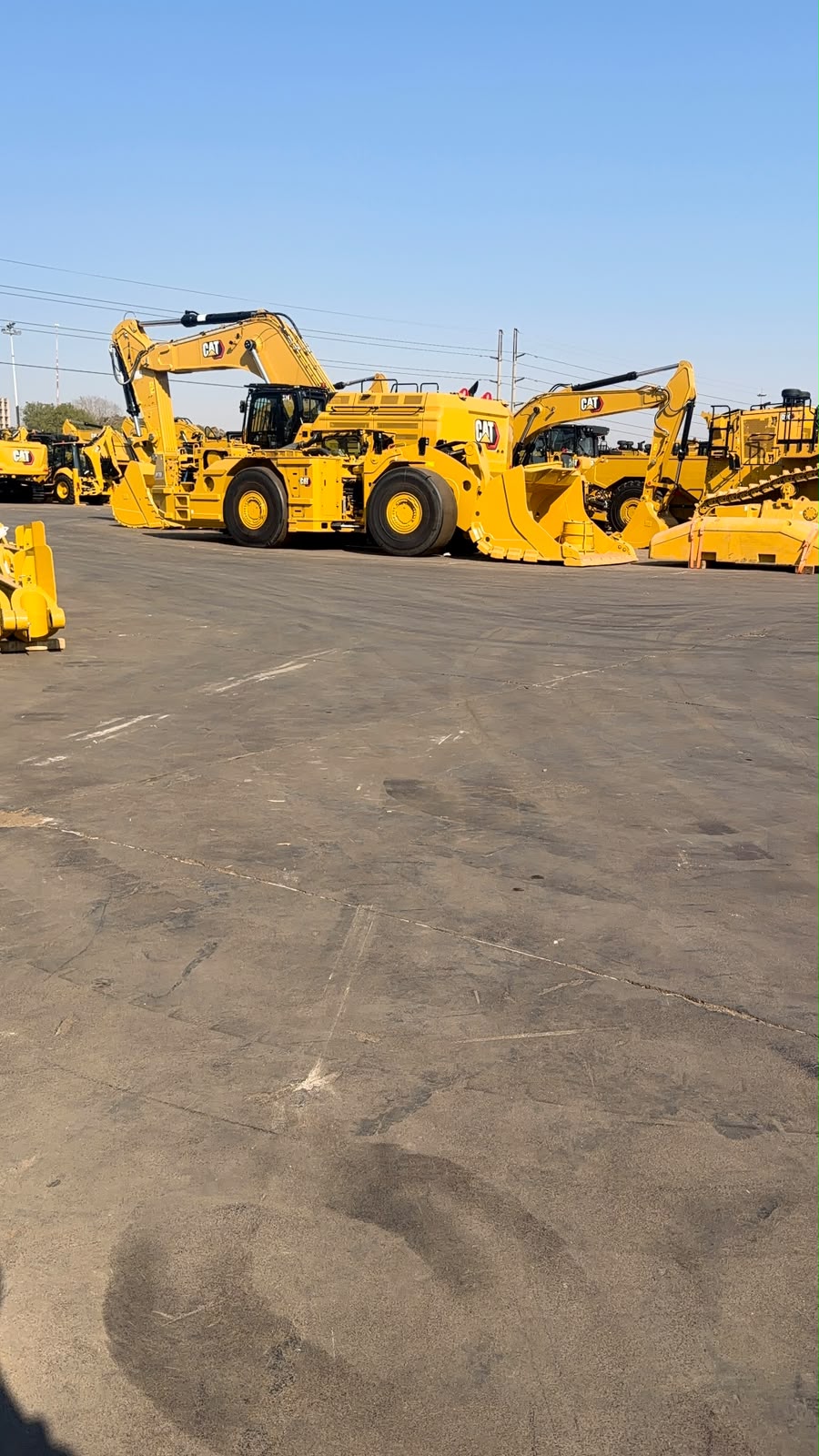 Yellow earthmoving equipment in a plant yard