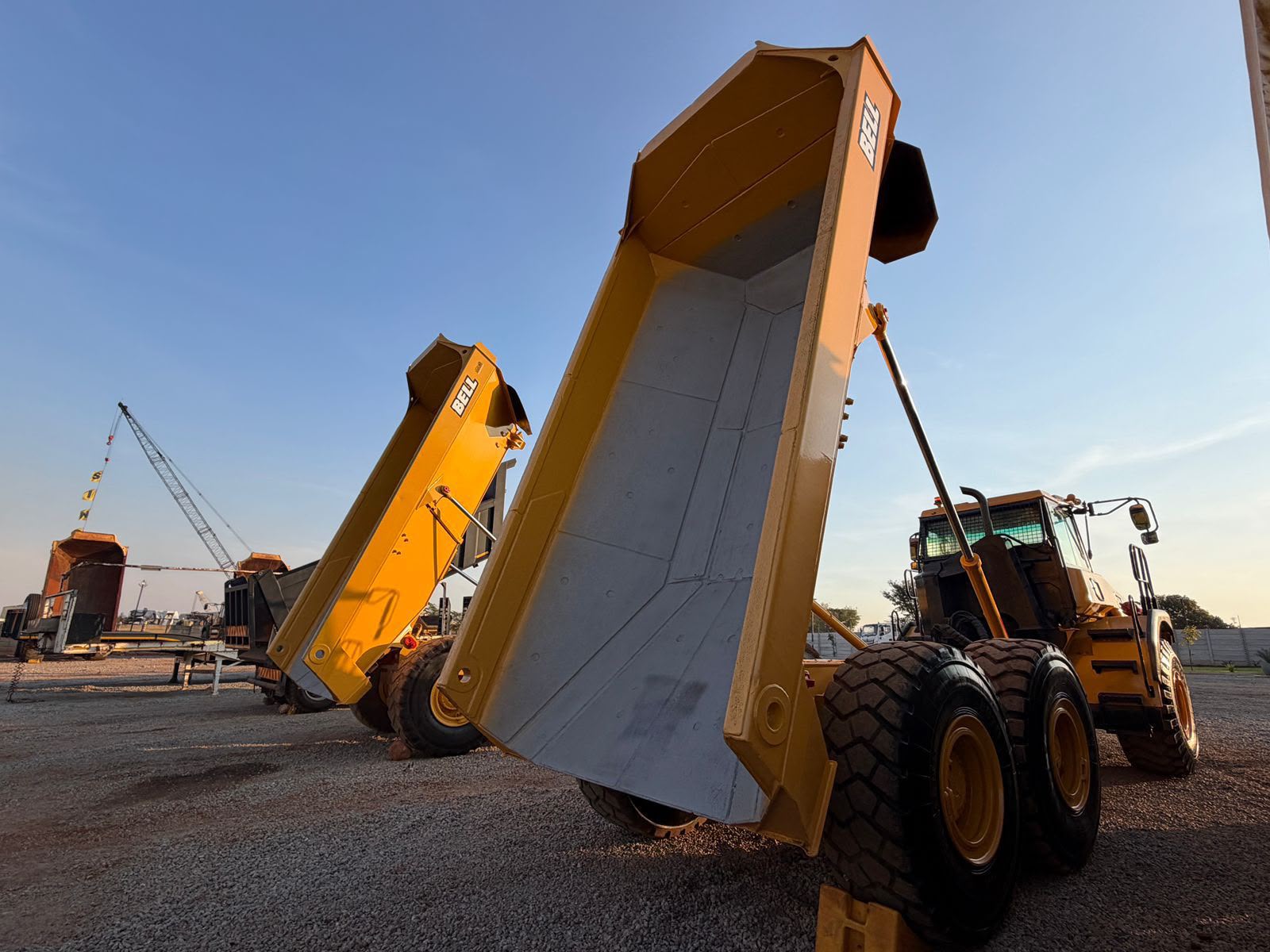 Bell articulated dump trucks with bodies raised